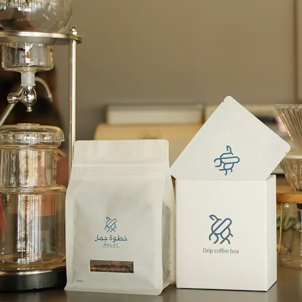 Premium custom paper box and coffee bag shown in a café environment for branding display