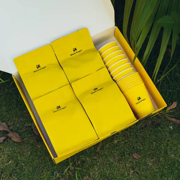 Inside view of a custom paper coffee box featuring neatly arranged coffee bags and cups