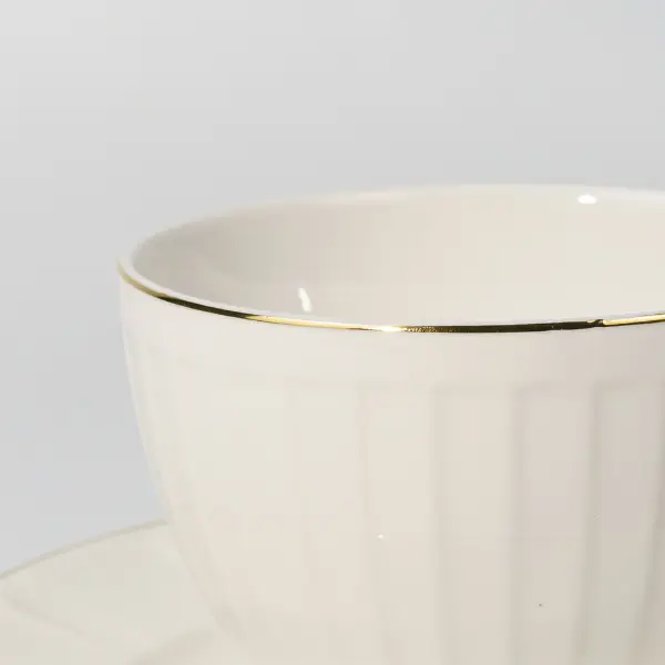 Gold-painted rim detail on custom embossed ceramic coffee mug